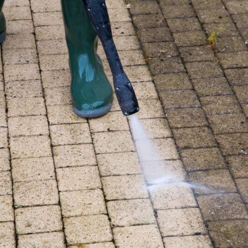 A Professional Is Cleaning Commercial Building Outdoor Floor With High Pressure Water Jet